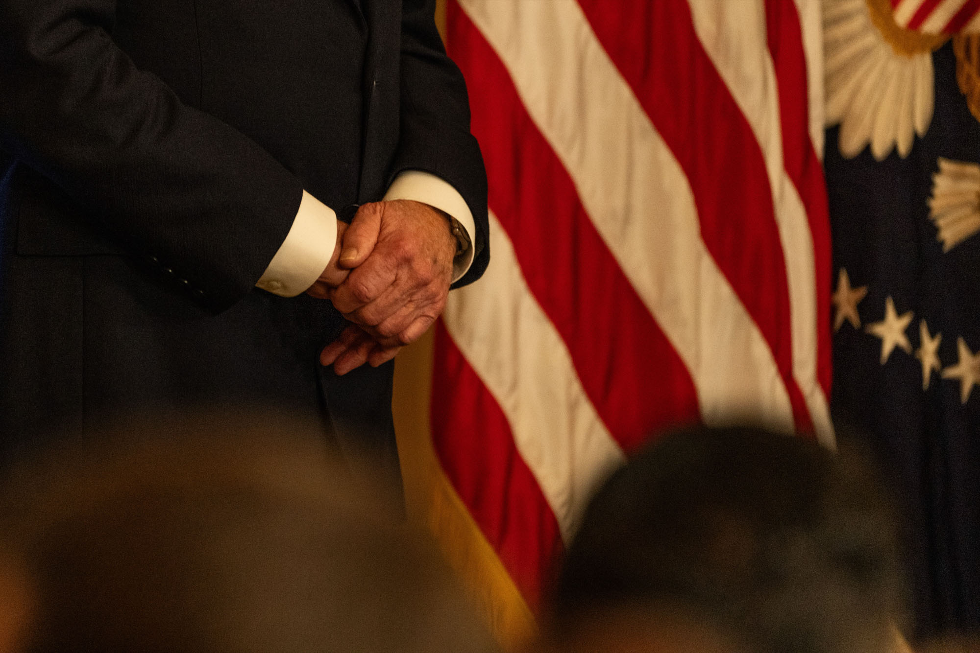 Biden holds his hands together as he waits to speak at a White House event, establishing two new national monuments in California on Jan. 14, 2025.